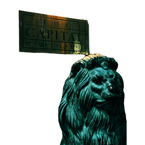 A Statue Of A Lion In Front Of A Sign – cat PNG with transparent background